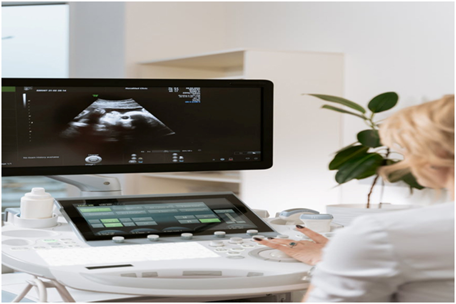 A sonographer looking at the ultrasound image